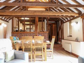 A dining room with a table and chairs at WEST LODGE in Ashford