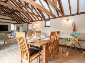 A dining room with a table set for dinner at WEST LODGE in Ashford