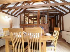 A dining room with wooden furniture at WEST LODGE in Ashford