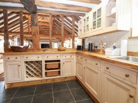 A kitchen with cabinets and a sink at WEST LODGE Ashford