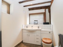 A bathroom with a sink and toilet at WEST LODGE Ashford