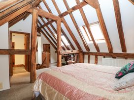 A bedroom with a bed and desk at WEST LODGE in Ashford