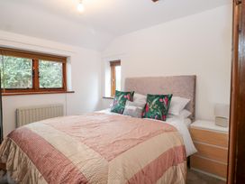 A bedroom with a bed and windows at WEST LODGE Ashford