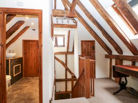 A corridor with stairs and doors at WEST LODGE in Ashford