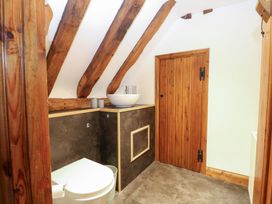 A bathroom with a sink and toilet at WEST LODGE in Ashford