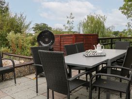 An outdoor seating area with a table and chairs at WEST LODGE in Ashford