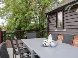 An outdoor dining table with chairs at WEST LODGE in Ashford