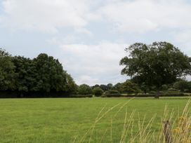 A field with trees and a cloudy sky at WEST LODGE Ashford