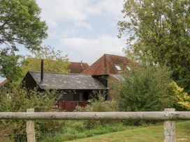 A house with a chimney and trees at WEST LODGE in Ashford