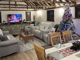 A living room with a television and Christmas tree at WEST LODGE in Kingsnorth