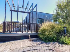 A deck with support beams and outdoor seating at Gwel An Mor in Portreath