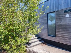 A building entrance with steps and bushes at Gwel An Mor in Portreath