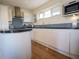 A kitchen with cabinets and appliances at Gwel An Mor in Portreath
