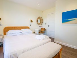 A bedroom with a bed and a desk at Gwel An Mor in Portreath