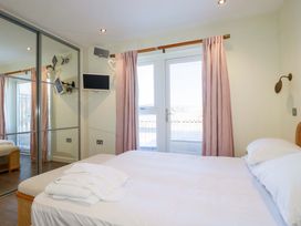 A bedroom with a bed and a television at Gwel An Mor Portreath