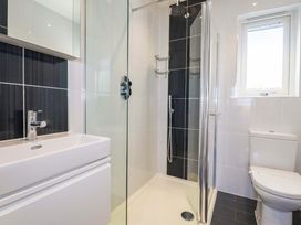 A bathroom with a shower, sink, and toilet at Gwel An Mor in Portreath