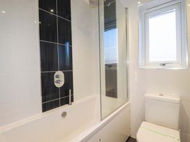 A bathroom with a bathtub and toilet at Gwel An Mor in Portreath
