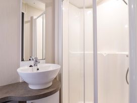 A bathroom with a sink and shower at Sea Breeze C38 Dyffryn Seaside Estate Dyffryn Ardudwy