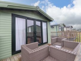 A balcony with seating at Sea Breeze C38 Dyffryn Seaside Estate Dyffryn Ardudwy