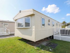 A caravan with windows and steps at Beachcombers Barmouth Bay Holiday Park Talybont near Dyffryn Ardudwy