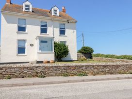 A house with windows and a door on the exterior at Tregundy Farmhouse Perranporth