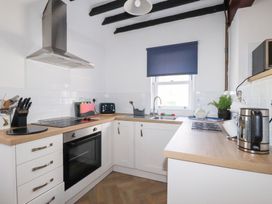 A kitchen with appliances and utensils at Tregundy Farmhouse in Perranporth