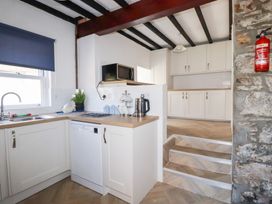 A kitchen with a sink and appliances at Tregundy Farmhouse in Perranporth