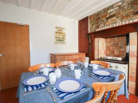 A dining room with a table set for breakfast at Tregundy Farmhouse in Perranporth