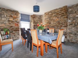 A dining room with a table and chairs at Tregundy Farmhouse Perranporth