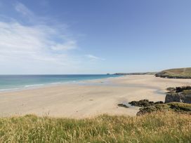 A beach with sand and ocean view at Tregundy Farmhouse Perranporth