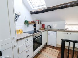 A kitchen with appliances and a window at The Little Laura Ashley House Machynlleth