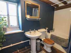 A bathroom with a sink, toilet, and bathtub at The Little Laura Ashley House Machynlleth