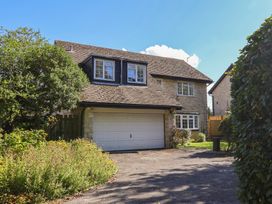 A house with a garage and a driveway at Oakwood in Chideock