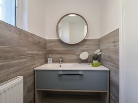 A bathroom with a sink and mirror at Oakwood in Chideock