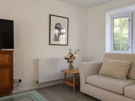 A living room with a television and sofa at Oakwood in Chideock