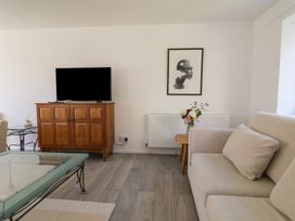 A living room with a television and a coffee table at Oakwood in Chideock