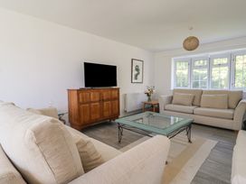 A living room with a sofa and coffee table at Oakwood in Chideock
