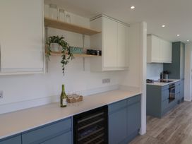 A kitchen with cabinets and a wine cooler at Oakwood in Chideock
