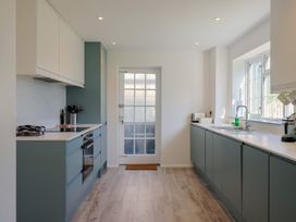 A kitchen featuring a sink, cooker, and door at Oakwood in Chideock