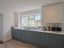 A kitchen with a sink and appliances at Oakwood in Chideock