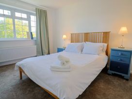 A bedroom with a bed and bedside tables at Oakwood in Chideock