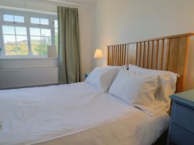 A bedroom with a bed and lamp at Oakwood in Chideock