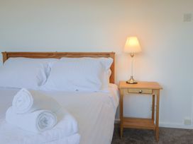 A bedroom with a bed and a nightstand at Oakwood in Chideock
