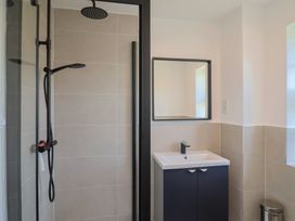 A bathroom with a shower and sink at Oakwood in Chideock