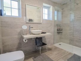 A bathroom with a wash basin and shower at Oakwood in Chideock