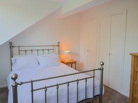 A bedroom featuring a bed and lamps at Oakwood in Chideock
