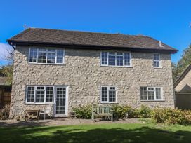 A house with windows and a garden bench at Oakwood in Chideock