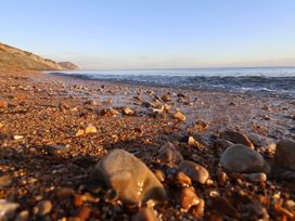 A beach with pebbles and water at Oakwood in Chideock