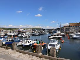 A harbor with boats and buildings at Oakwood in Chideock
