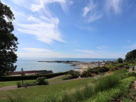 A beach view with boats and a pier at Oakwood in Chideock